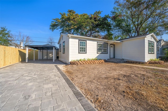 ranch-style house featuring a carport