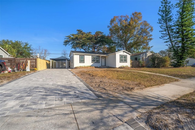 ranch-style home with a front yard and a carport