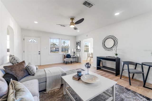 living room featuring wood-type flooring and ceiling fan