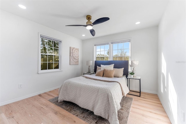 bedroom with ceiling fan and light wood-type flooring