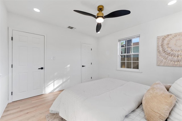 bedroom with ceiling fan and light hardwood / wood-style floors