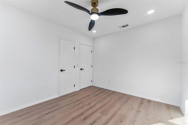 unfurnished bedroom with ceiling fan and light hardwood / wood-style flooring