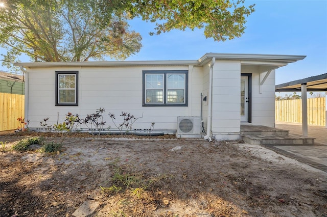 view of front of home with ac unit