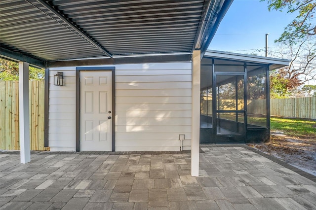 view of patio featuring a sunroom