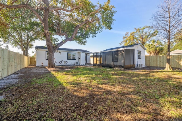 back of house featuring a lawn