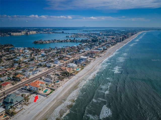 birds eye view of property with a water view and a view of the beach