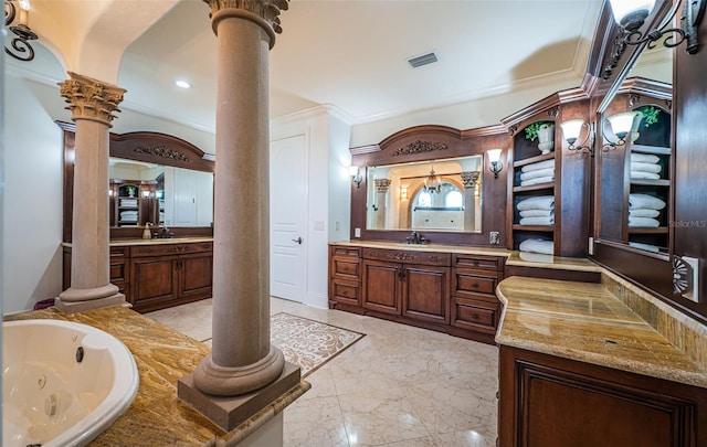 bathroom with ornate columns, vanity, and a tub to relax in