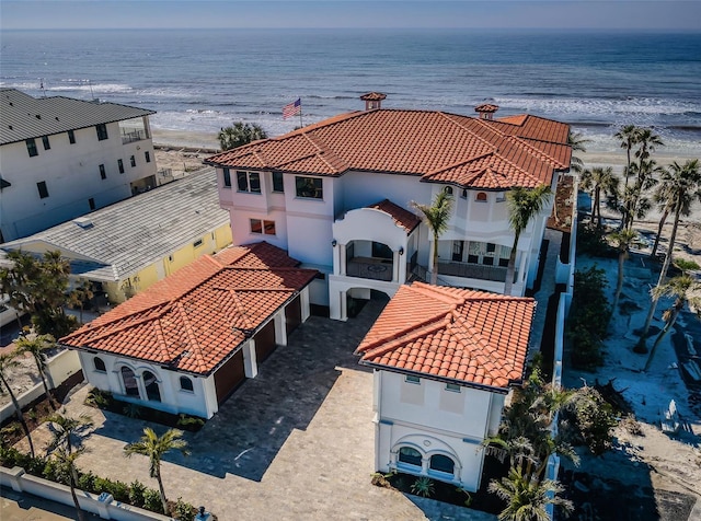 birds eye view of property featuring a water view and a beach view