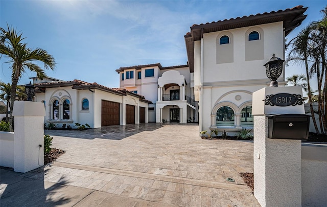 mediterranean / spanish home featuring a garage