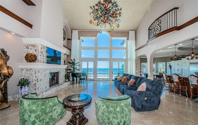 living room with a towering ceiling and a fireplace