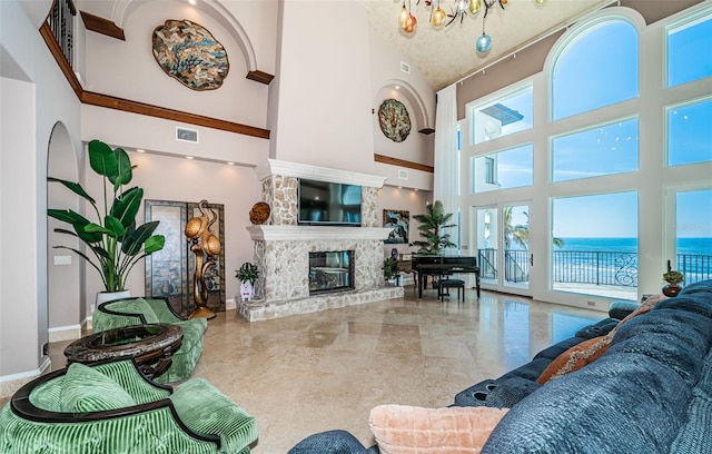 living room featuring a towering ceiling and a chandelier