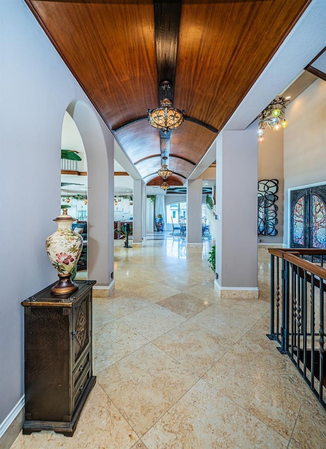 hall featuring lofted ceiling and wooden ceiling