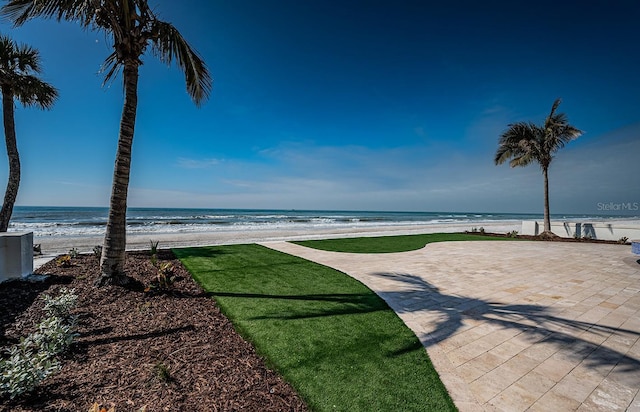 view of yard featuring a water view and a view of the beach