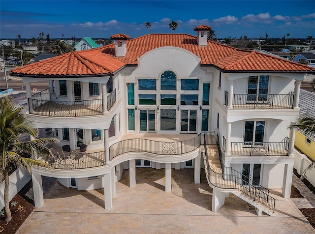 back of property featuring a balcony