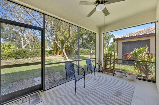 unfurnished sunroom featuring ceiling fan