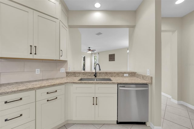 kitchen featuring sink, light stone countertops, dishwasher, and light tile patterned flooring