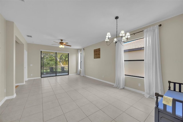 interior space featuring ceiling fan with notable chandelier and light tile patterned floors