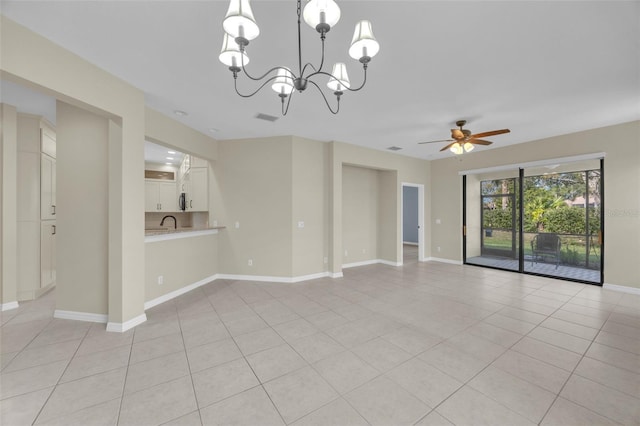 spare room featuring ceiling fan with notable chandelier and light tile patterned flooring