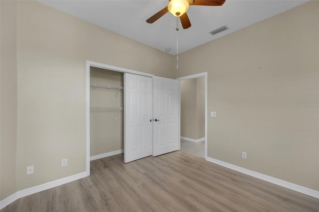 unfurnished bedroom featuring light hardwood / wood-style floors, a closet, and ceiling fan