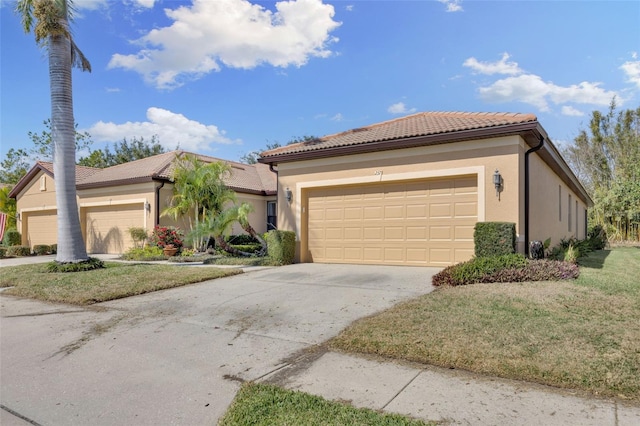 view of front of home with a garage and a front lawn