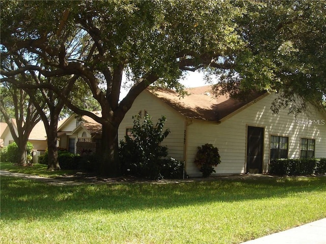 view of home's exterior with a yard