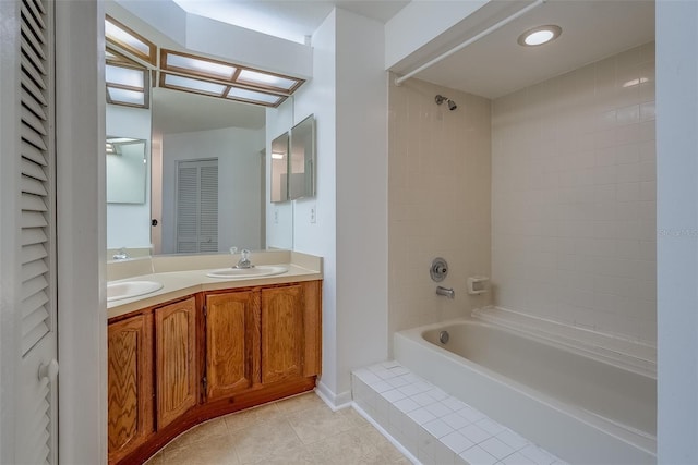 full bath featuring double vanity, shower / bathing tub combination, a sink, and tile patterned floors