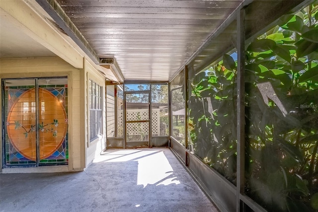 unfurnished sunroom featuring wooden ceiling