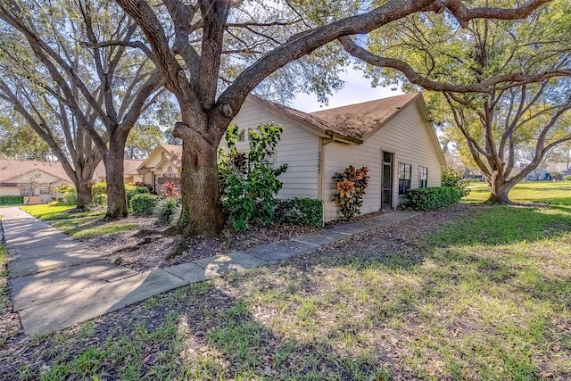 view of side of home with a lawn