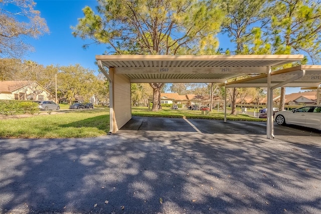 covered parking lot featuring a residential view