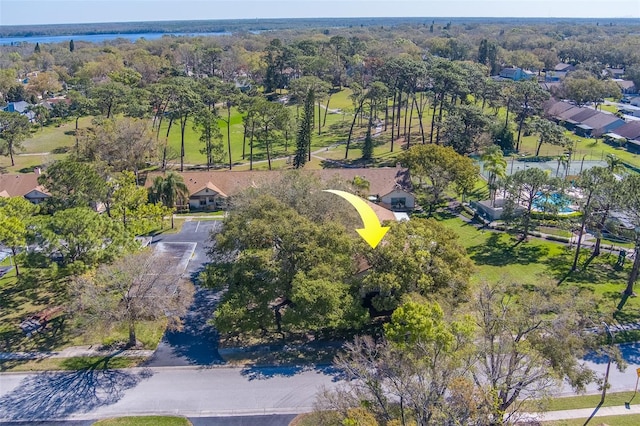 drone / aerial view with a residential view and a view of trees