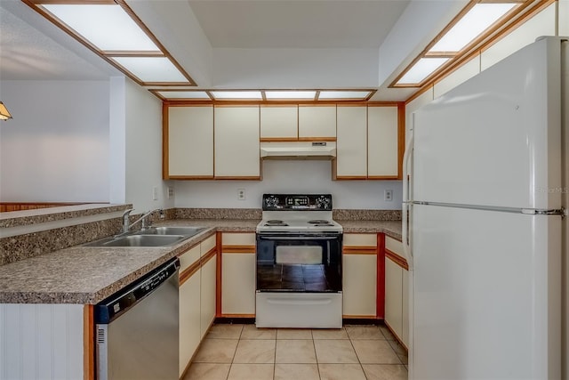 kitchen with range with electric stovetop, stainless steel dishwasher, freestanding refrigerator, a sink, and under cabinet range hood