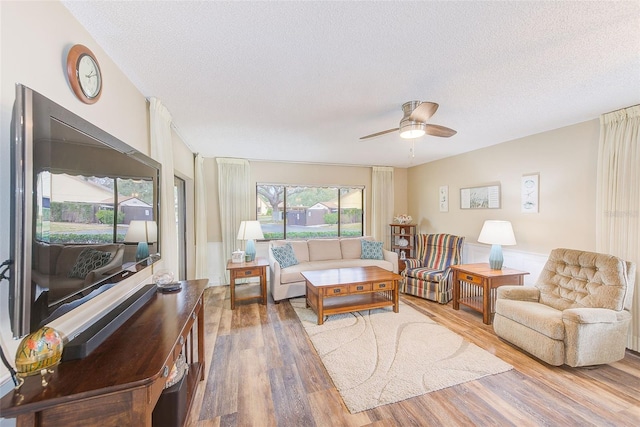 2546 Oakleaf Ln Unit 35D, Clearwater, FL 33763 - living area featuring wood finished floors, a textured ceiling, and a ceiling fan