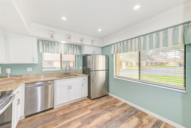 2546 Oakleaf Ln Unit 35D, Clearwater, FL 33763 - kitchen with appliances with stainless steel finishes, a sink, white cabinets, light stone countertops, and plenty of natural light