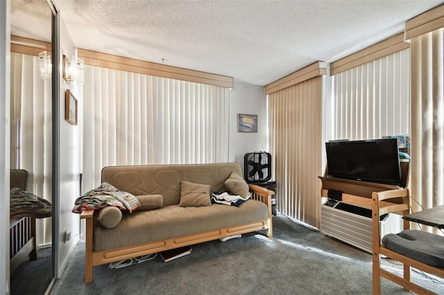 living room featuring dark carpet and a textured ceiling