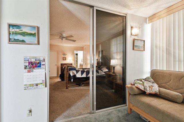 interior space featuring ceiling fan, carpet flooring, and a textured ceiling