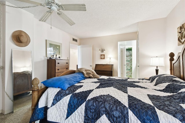 carpeted bedroom with ceiling fan and a textured ceiling