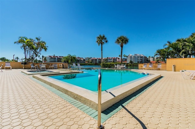 view of pool with a hot tub and a patio area