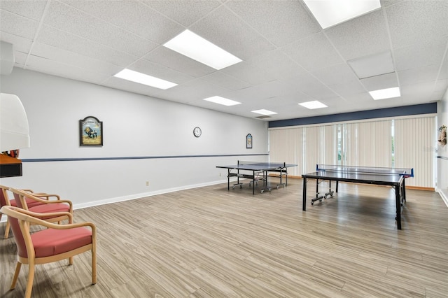 rec room with a paneled ceiling and wood-type flooring