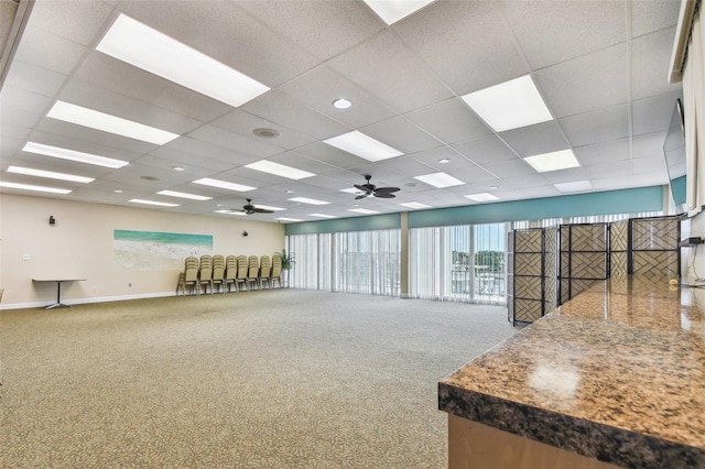 carpeted spare room with a drop ceiling