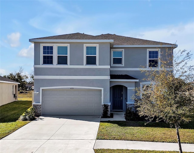 view of front of property with a garage and a front lawn