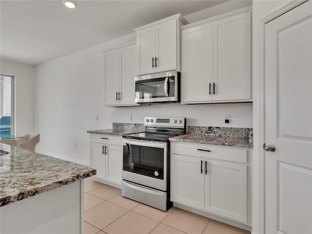 kitchen featuring light stone countertops, white cabinets, and appliances with stainless steel finishes