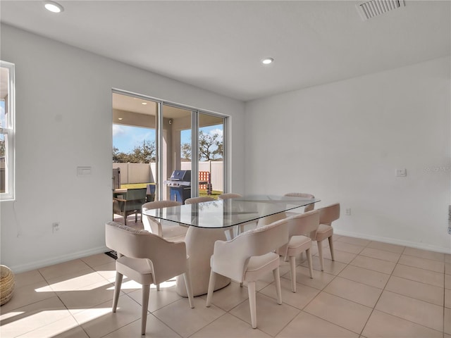 dining space featuring light tile patterned floors