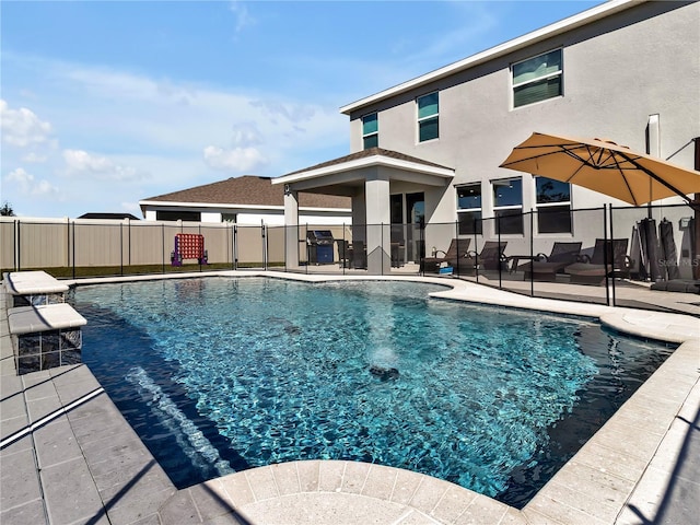 view of pool featuring area for grilling and a patio