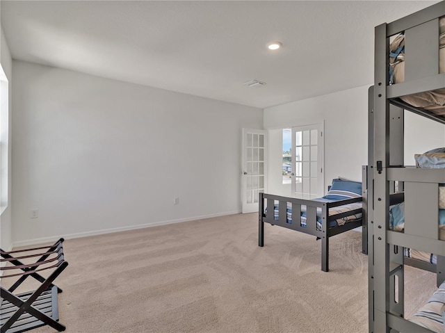 carpeted bedroom featuring french doors