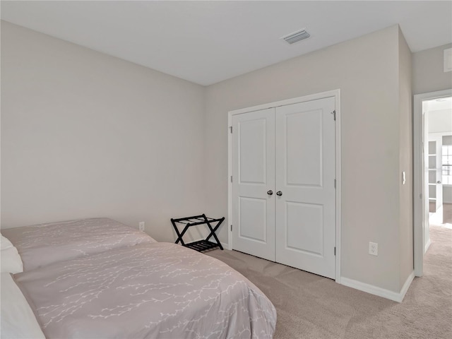 carpeted bedroom featuring a closet