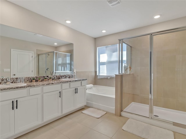 bathroom with tile patterned floors, shower with separate bathtub, and vanity