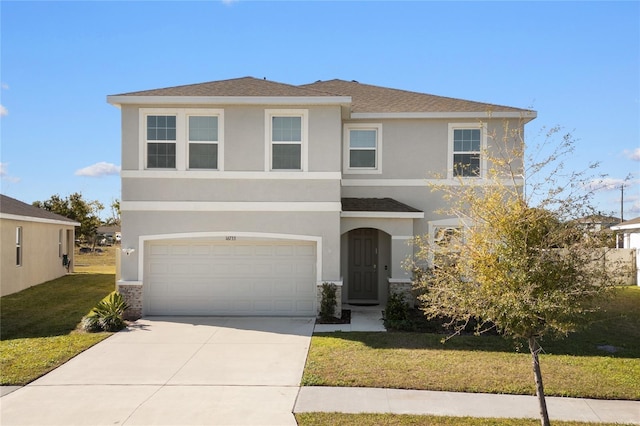 view of front of property with a garage and a front lawn