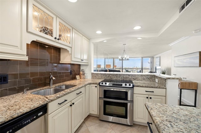 kitchen featuring light stone counters, stainless steel appliances, sink, and white cabinets