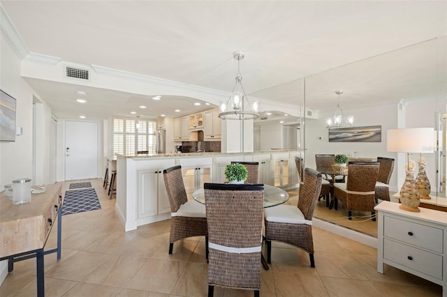 tiled dining room featuring crown molding and an inviting chandelier