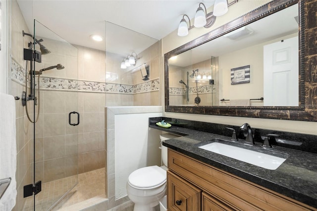 bathroom featuring vanity, toilet, and walk in shower